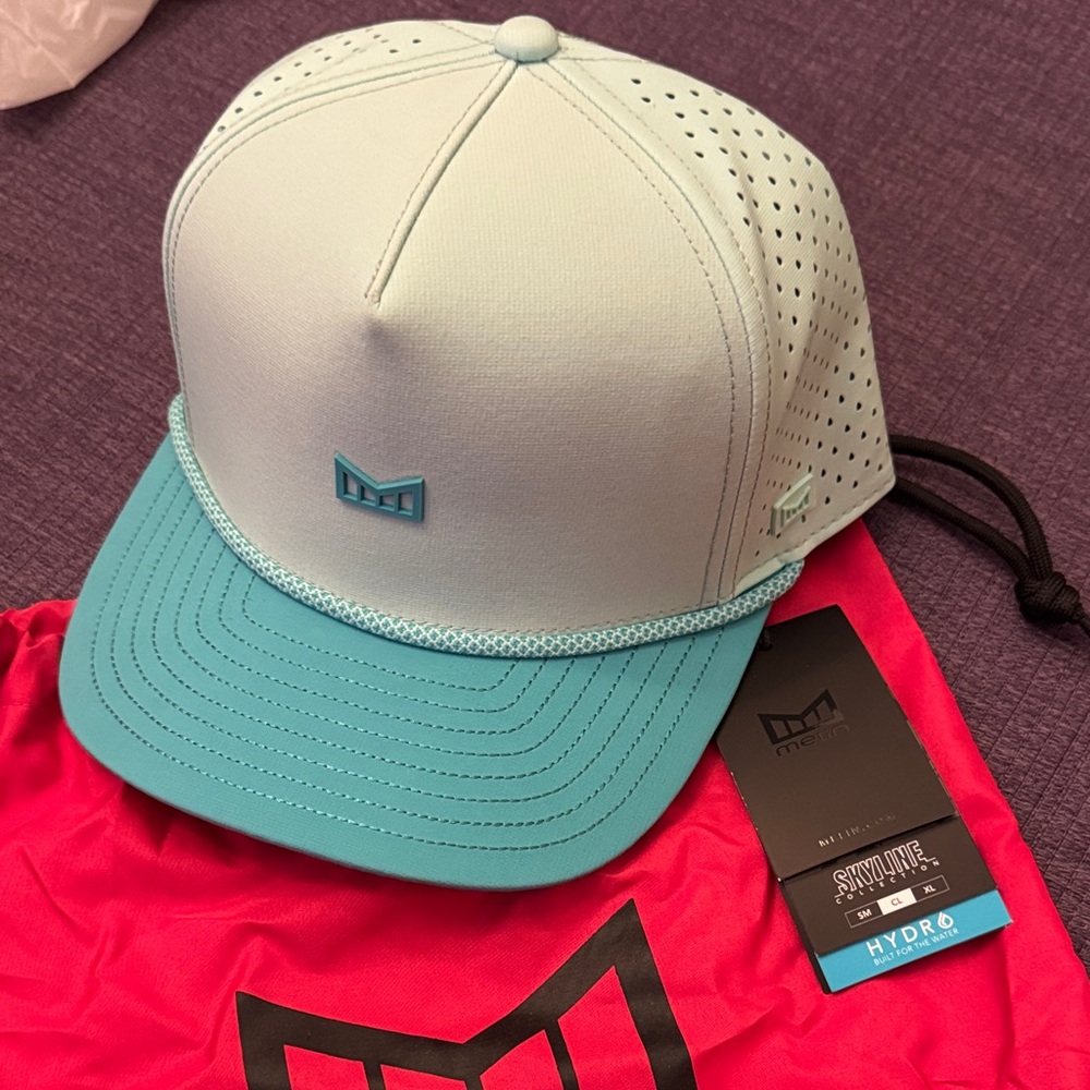 Melin “Skyline” Teal Cap with Logo with red cinch bag